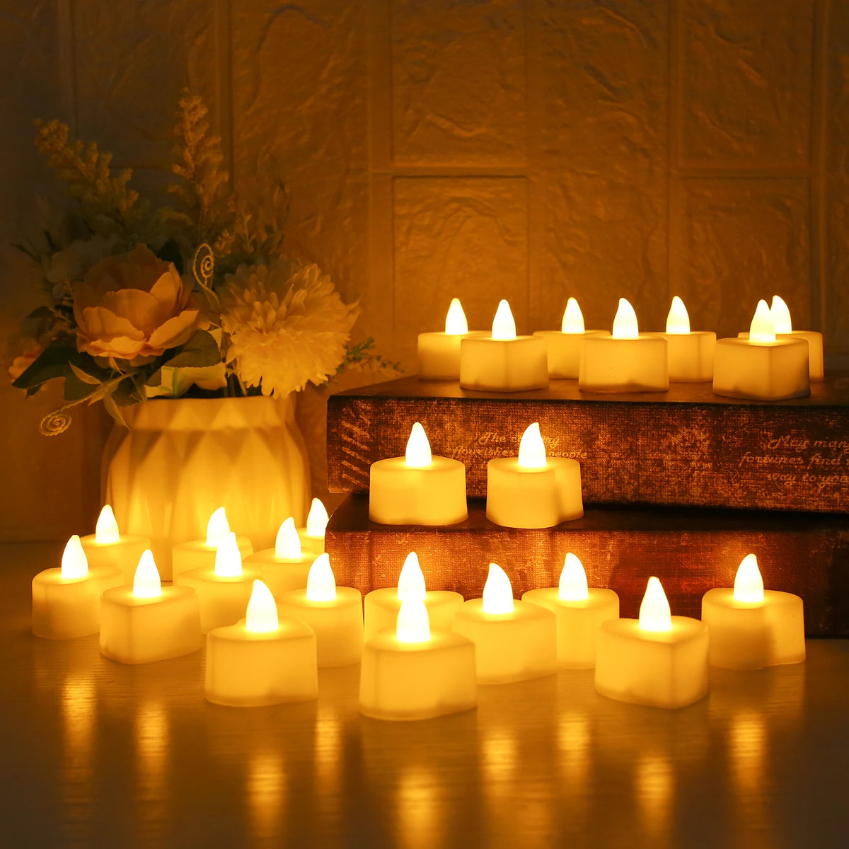 A collection of glowing white LED tea lights arranged on a wooden surface with artificial rose petals in a warm, soft light.