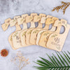 A set of wooden baby closet dividers with engraved names and leaves arranged on a light gray surface.