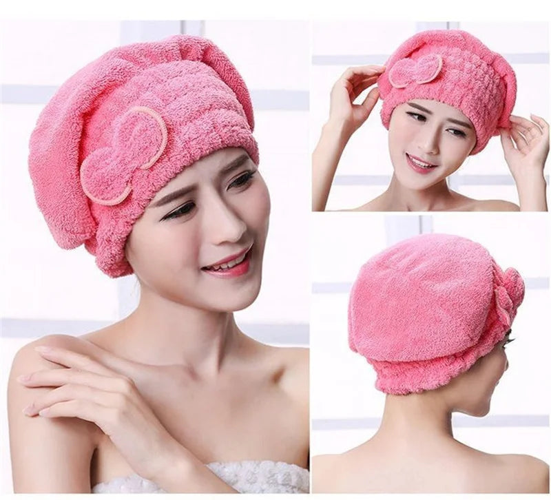 A woman is shown wearing a pink microfiber hair drying towel cap on her head.