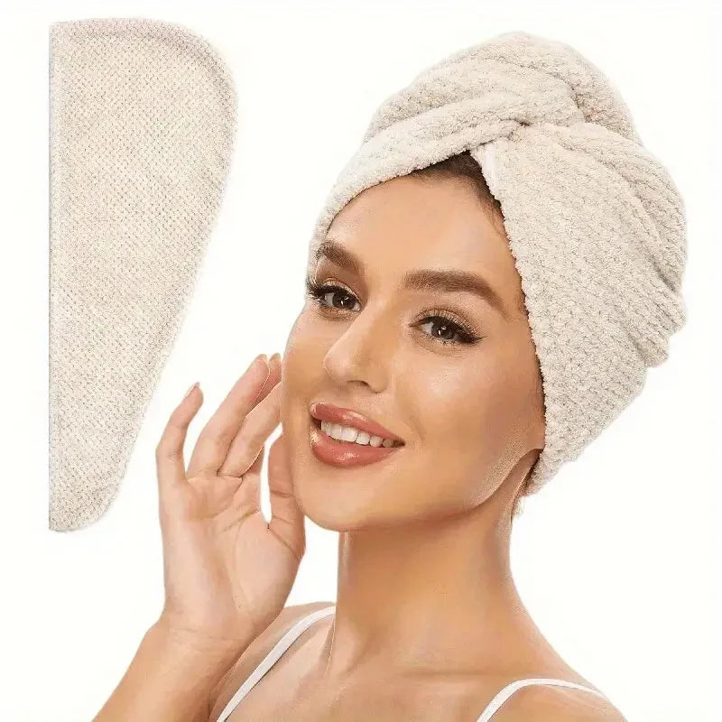 A woman is wearing a beige soft microfiber hair drying towel wrap on her head.