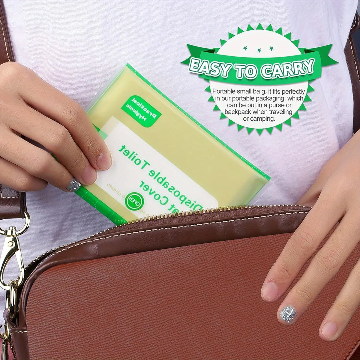 A hand is holding a green disposable toilet seat cover package inside a brown leather handbag.