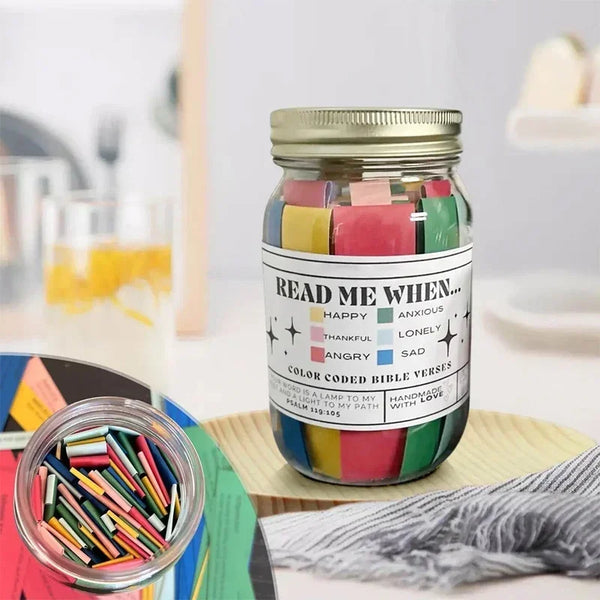 A glass jar filled with colorful scripture verses, including happy, anxious, thankful, angry, lonely, and sad themes.