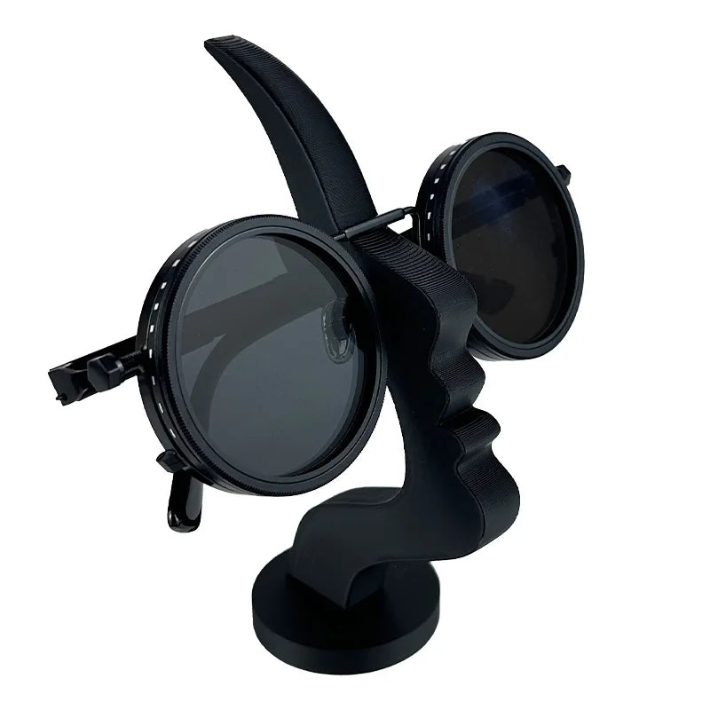 A black minimalist 3D printed profile eyeglass stand with two circular holders.