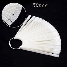 A fan-shaped set of white false nails for practice, showing the tips and a full display.