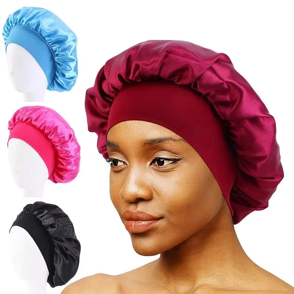 A woman models a deep maroon satin wide-brim sleeping bonnet, with separate blue and pink satin bonnets shown.
