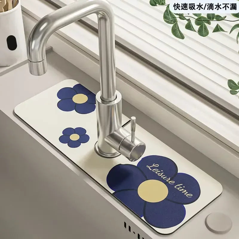 A modern chrome faucet mounted on a white mat decorated with blue and yellow flowers.