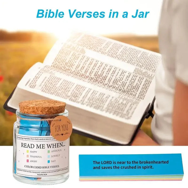 A jar filled with colorful Bible verses and a Bible open on a wooden surface.