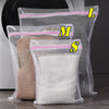 Three mesh laundry bags labeled L, M, and S are shown inside a washing machine drum.
