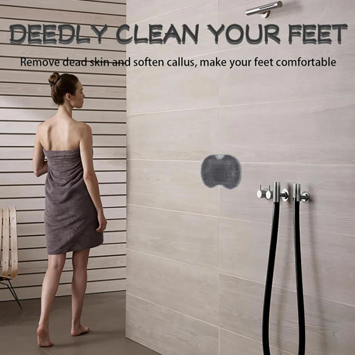 A woman stands next to a wall-mounted shower foot scrubber, demonstrating its use for cleaning and softening feet.