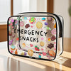 A clear plastic travel organizer pouch filled with colorful emergency snacks like lollipops and candies.