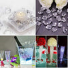 Crystal crushed ice stones used for decoration alongside candles and floral arrangements.