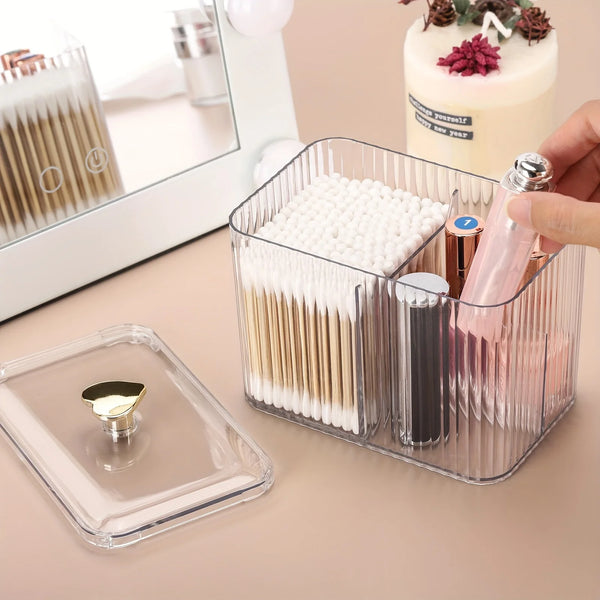 A clear plastic organizer jar holds various cosmetic items like cotton swabs and makeup brushes.
