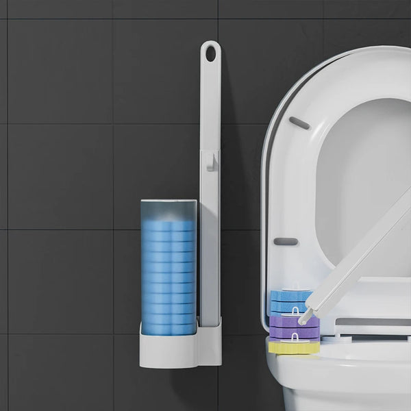 A wall-mounted disposable toilet brush with a handle and a container of blue cleaning pads is shown against a dark gray tiled