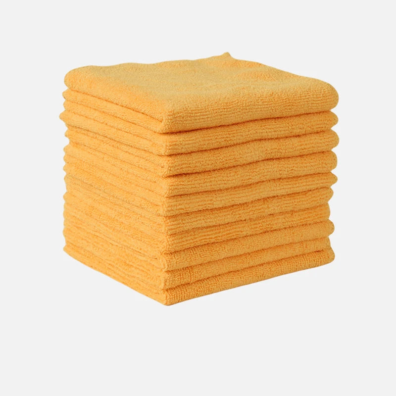 A stack of bright orange thickened microfiber cleaning cloths for glass and surfaces.