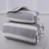 A stack of gray and white striped microfiber bath towels