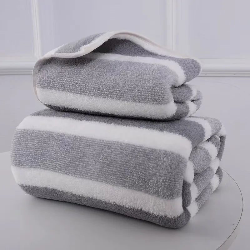 A stack of gray and white striped microfiber bath towels