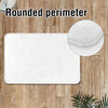 White botanical leaf carpet mat with a rounded perimeter placed on a wooden surface.