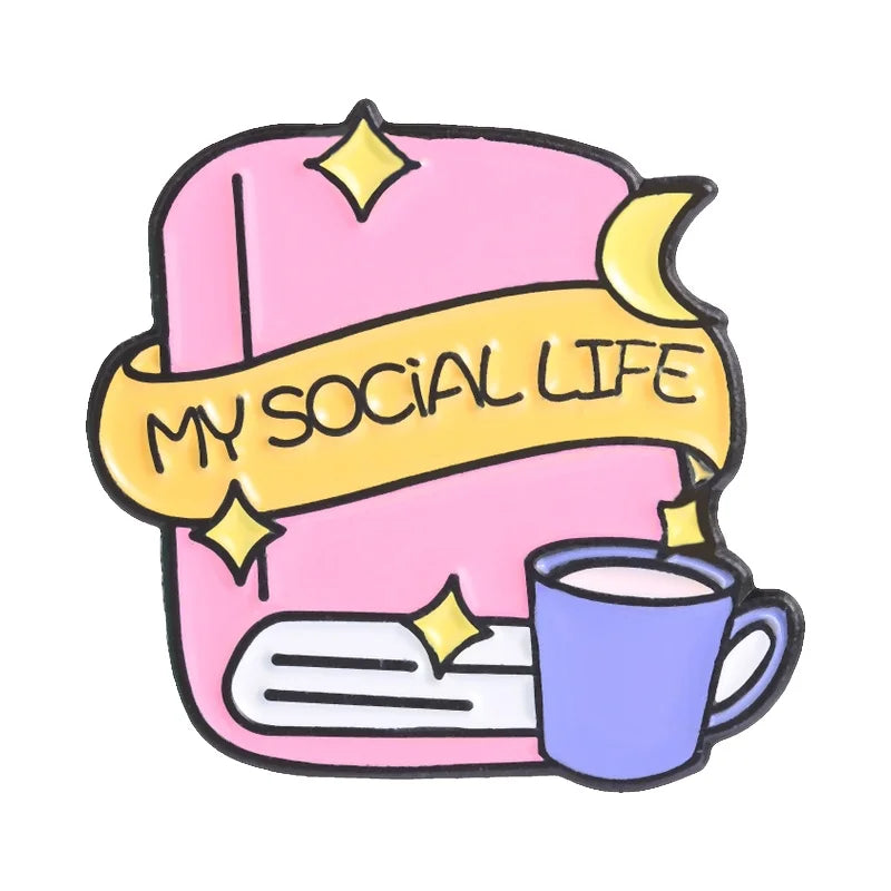 Un pin de esmalte rosa con una pancarta amarilla que dice MY SOCIAL LIFE y una taza morada.