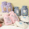 A collection of purple and gray plush cartoon hot water bottles featuring bears and other characters.