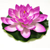 A vibrant pink artificial lotus flower with layered petals resting on a green leaf.