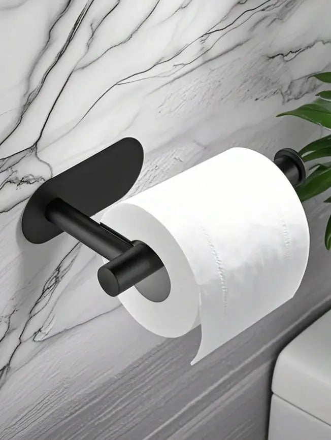 A black stainless steel self-adhesive toilet paper holder mounted on a marble wall.