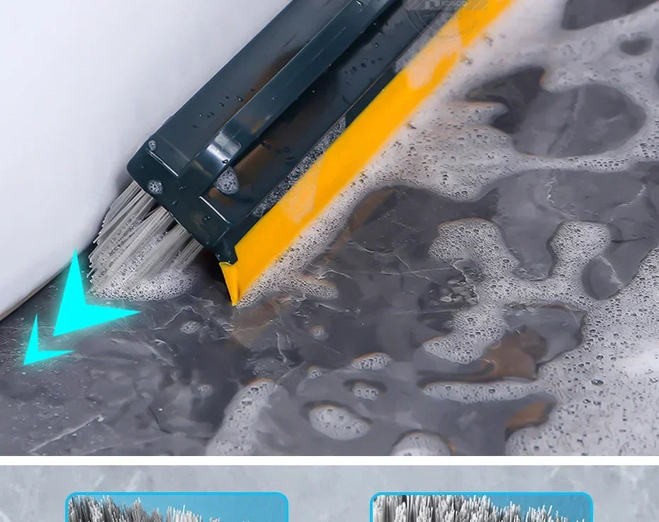 A close-up view of a yellow and black floor scrubbing brush being used to clean a dark, wet floor surface.