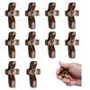 A set of handcrafted wooden pocket crosses in various finishes and sizes shown alongside a hand holding one.