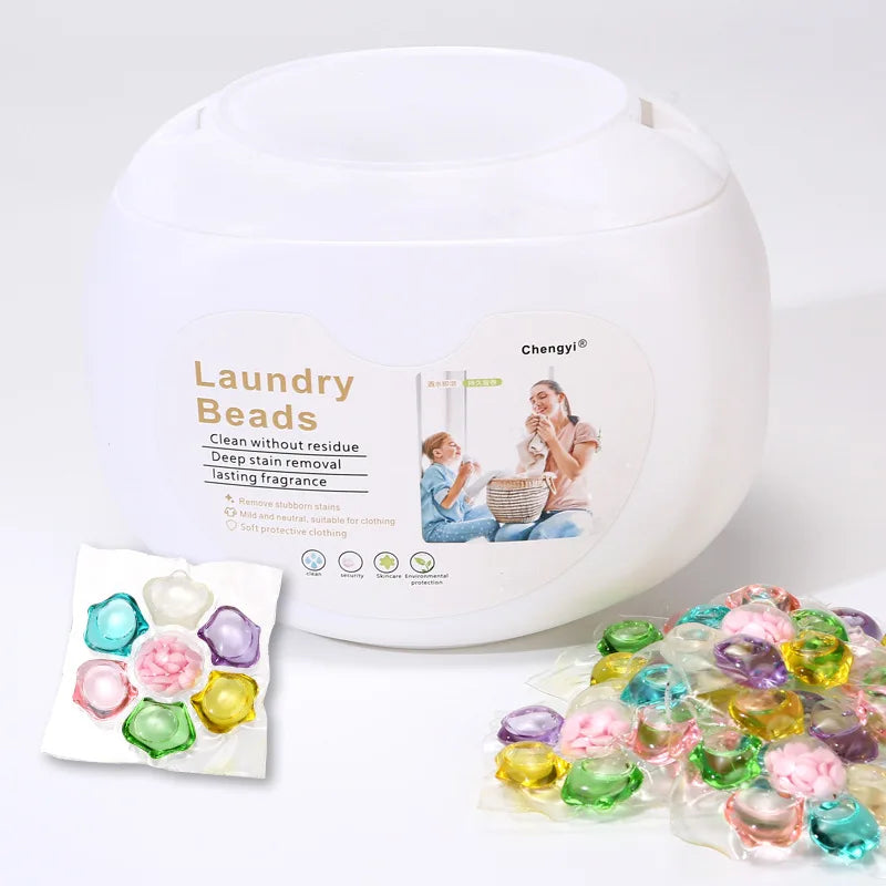 A white dispenser bottle of Laundry Beads with a small packet of beads and loose beads shown on a white background.