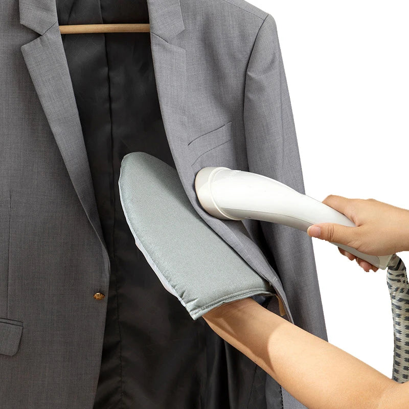 A hand is placing a white heat resistant ironing pad onto the collar of a gray suit jacket.