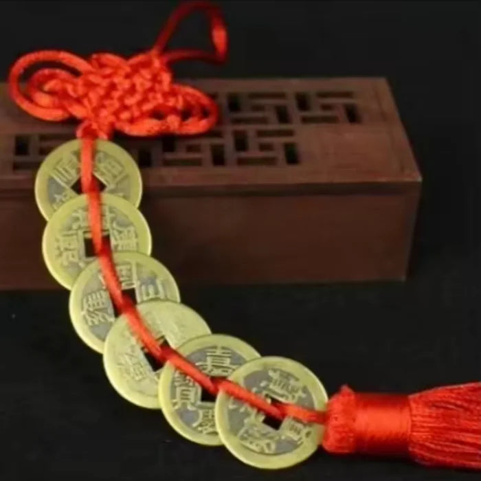 Handmade red knot feng shui coins for prosperity tied together on a string