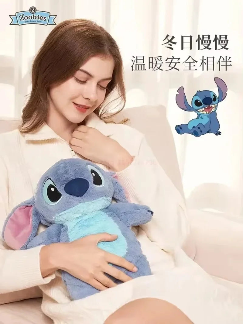 A woman is holding a blue cartoon plush toy, which is a hot water bottle, in a cozy indoor setting.