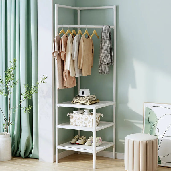 A white multi-layer corner coat rack with wooden hangers and a hanging gray coat in a light green room.