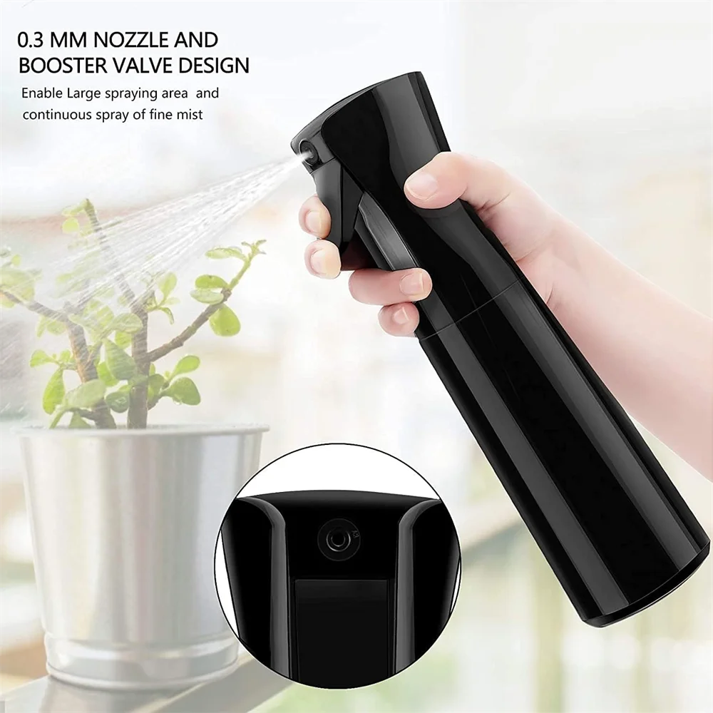 A hand holds a black handheld spray bottle with a nozzle design, demonstrating its large spraying area and fine mist capabili