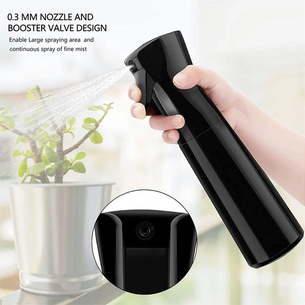 A hand holds a black handheld spray bottle with a nozzle design, demonstrating its large spraying area and fine mist capabili