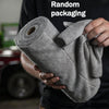 A hand holds a roll of gray tearable microfiber cleaning wipes.