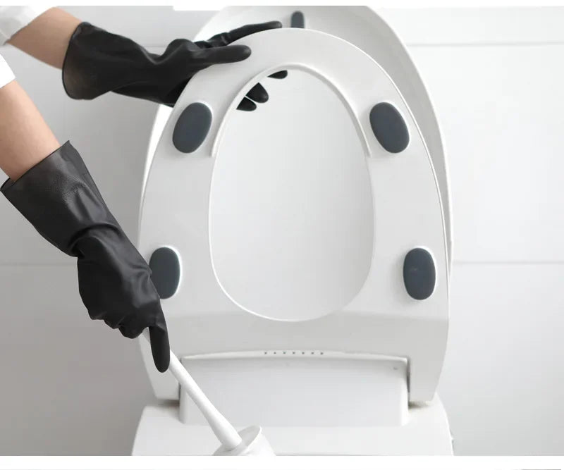 A person wearing black rubber cleaning gloves is operating a white reusable rubber cleaning glove machine.