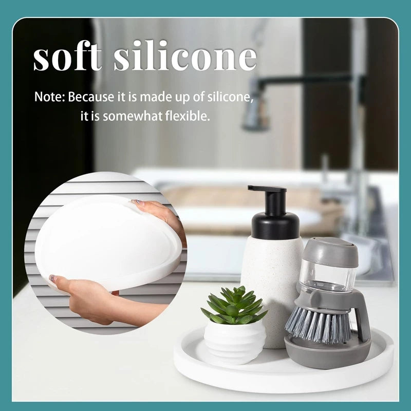 A white silicone tray organizer set is shown next to a plant and a small grinder on a white surface.