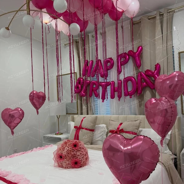 A pink heart birthday balloon set decorated with pink balloons and a large pink birthday sign