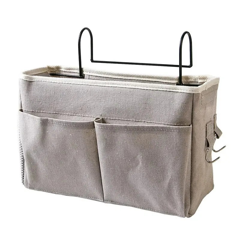 A light gray fabric storage box with two pockets and a black hanging rack.