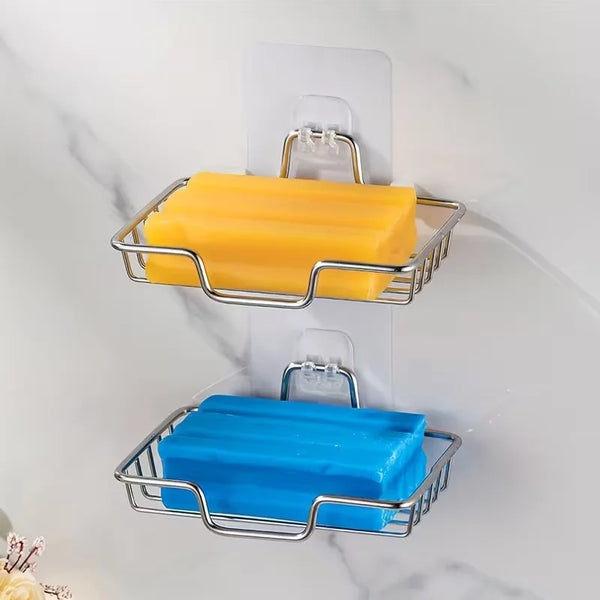 Stainless steel wall soap dish with adhesive mount holding a yellow bar of soap and a blue bar of soap