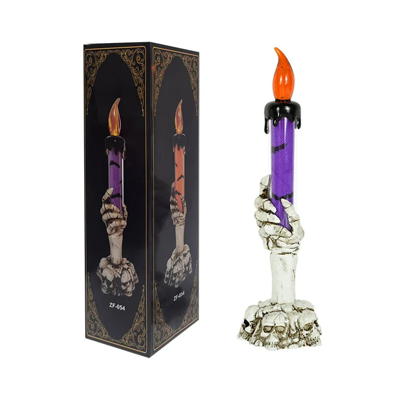A set of skeleton hand shaped Halloween LED candles with orange flames and purple wax.