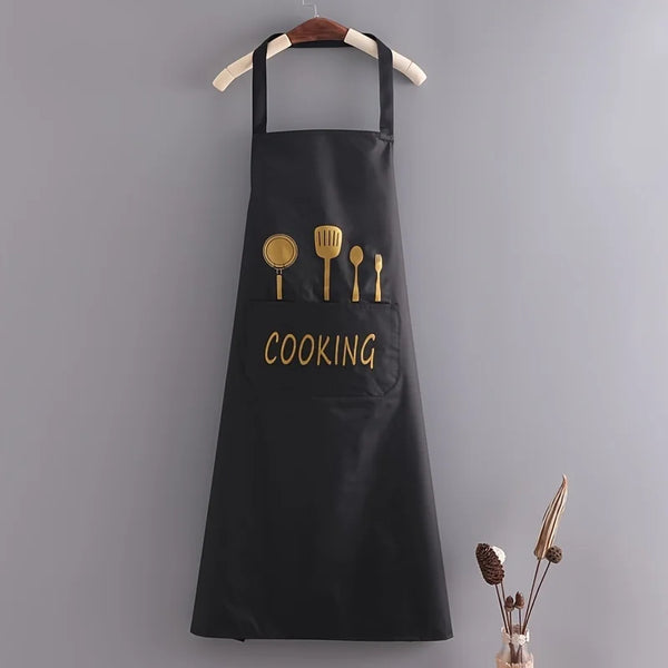 Black durable waterproof chef's apron hanging on a hook with gold cutlery displayed in the pocket