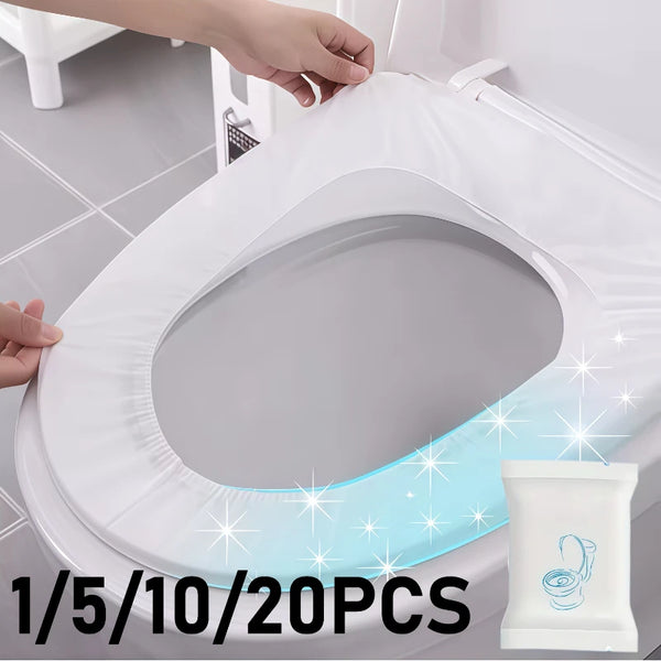 A hand is placing a white disposable toilet seat onto a white toilet bowl.