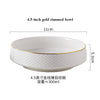 A white ceramic bowl with a gold rim, shown from above and to the side.