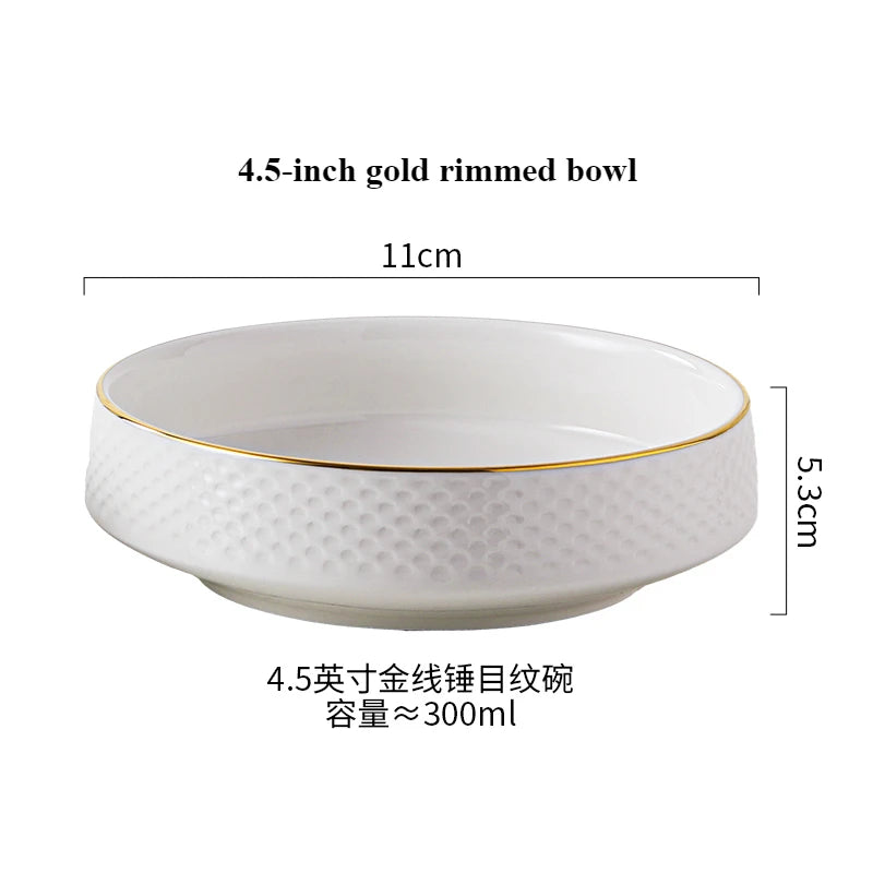 A white ceramic bowl with a gold rim, shown from above and to the side.