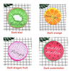 Four circular fruit designs on a grid: dark kiwi, dark orange, dark dragon fruit, and dark watermelon.