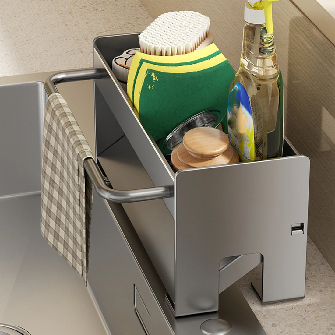A stainless steel kitchen sink caddy holds sponges, dish tools, and a bottle in a draining tray.