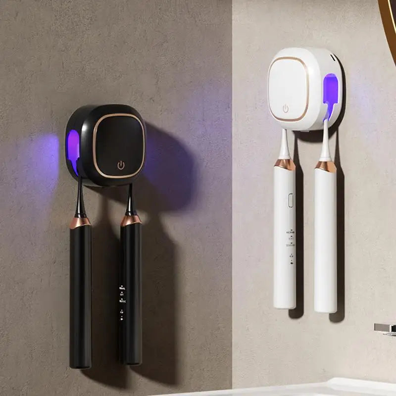A white portable UV electric toothbrush cleaner with two brush heads hanging on a wall.