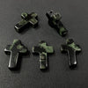 Three dark green natural agate and jasper cross pendant charms arranged on a black surface.