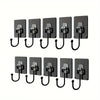 A set of black heavy-duty self-adhesive wall hooks with metal clasps.
